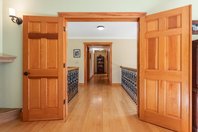 hallway featuring light hardwood / wood-style flooring and ornamental molding