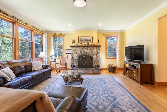 living room featuring a fireplace, light hardwood / wood-style floors, and crown molding