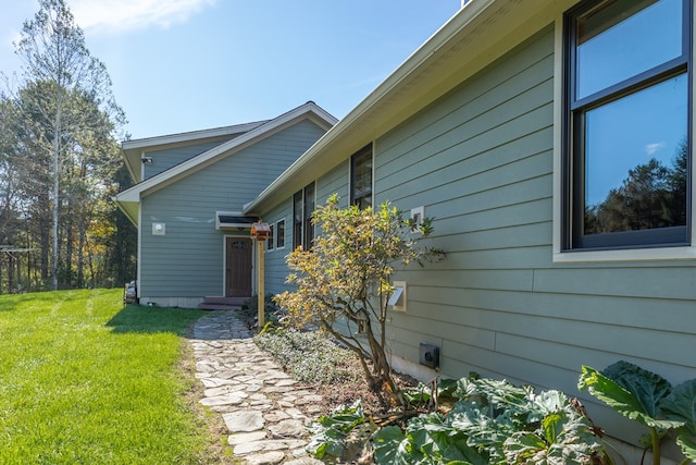 view of side of property with a yard