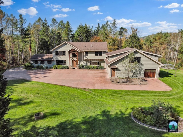 back of house featuring a yard and a garage