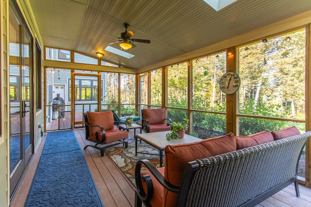 sunroom / solarium with ceiling fan, wooden ceiling, and lofted ceiling with skylight