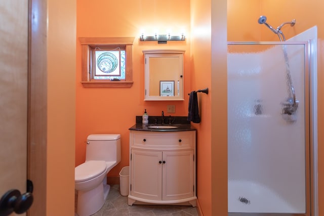 bathroom with tile patterned flooring, vanity, toilet, and an enclosed shower