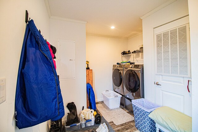 laundry room featuring independent washer and dryer, ornamental molding, electric panel, wood finished floors, and recessed lighting