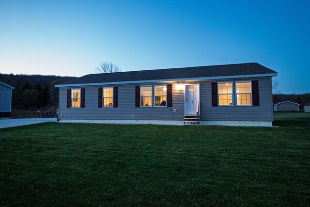 view of front of house featuring a lawn and entry steps