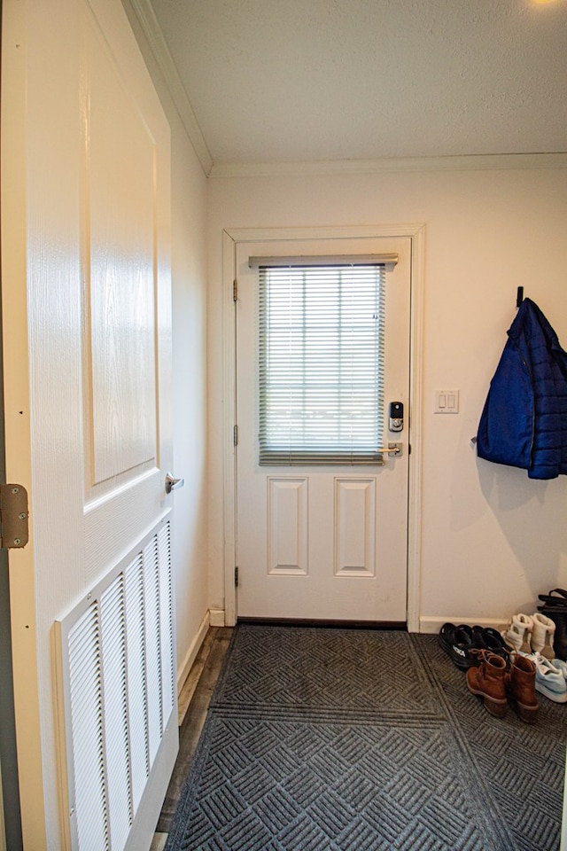doorway to outside with ornamental molding, baseboards, and dark wood-style flooring