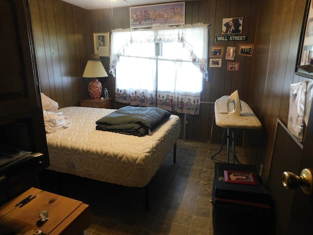 bedroom featuring wooden walls