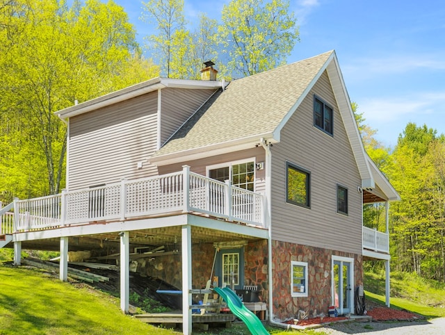 543 Drybrook Rd, Waverly, NY 14892 - rear view of property with roof with shingles, a deck, stone siding, and a chimney