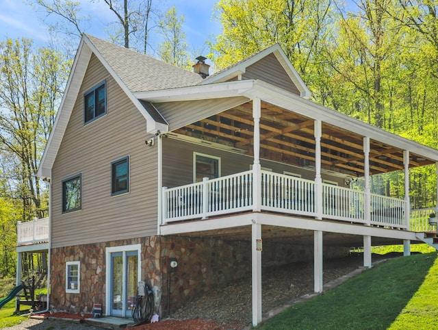 543 Drybrook Rd, Waverly, NY 14892 - back of property featuring a chimney, roof with shingles, stone siding, and a wooden deck