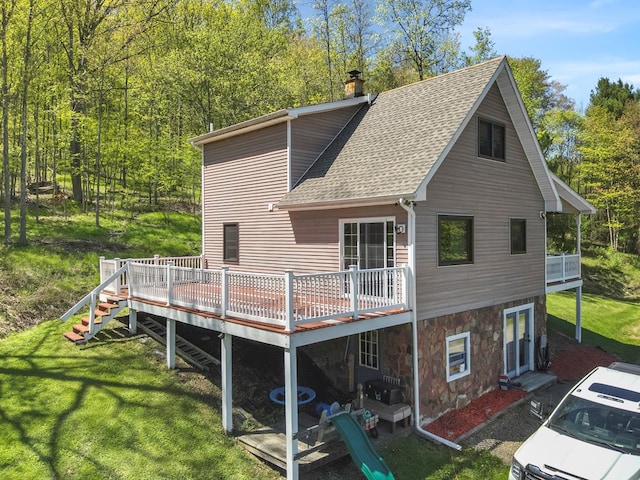 543 Drybrook Rd, Waverly, NY 14892 - back of property featuring roof with shingles, stone siding, a lawn, and a wooden deck