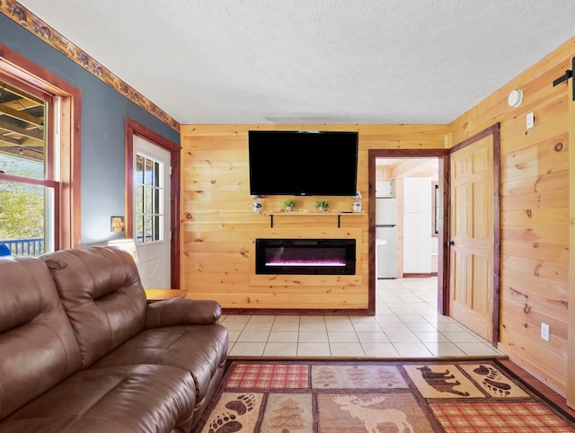 543 Drybrook Rd, Waverly, NY 14892 - living area featuring wooden walls, a glass covered fireplace, a textured ceiling, and light tile patterned floors