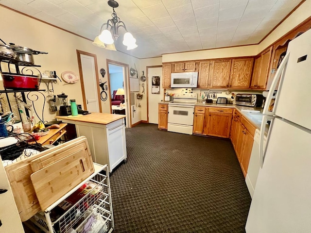 kitchen featuring dark colored carpet, a chandelier, hanging light fixtures, ornamental molding, and white appliances