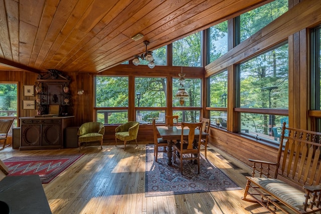 sunroom / solarium with lofted ceiling, plenty of natural light, and wooden ceiling