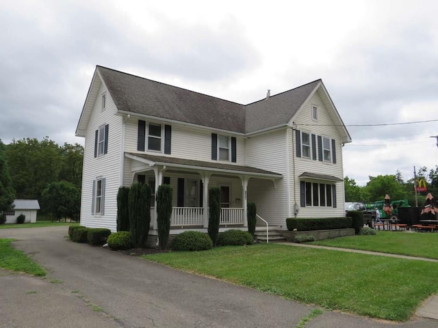 view of front of property with covered porch and a front lawn