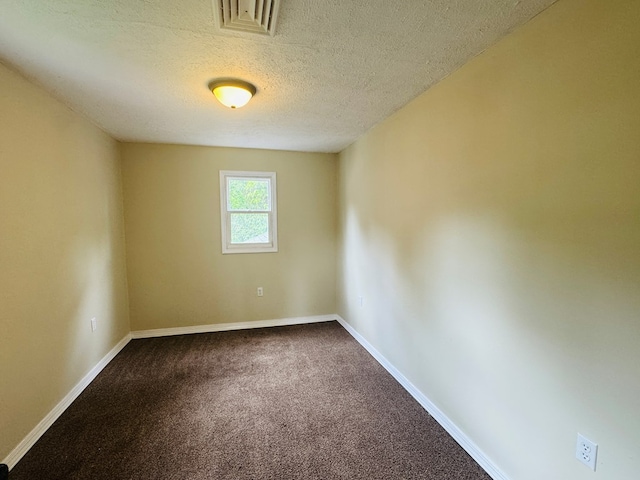 96 E St, Towanda, PA 18848 - empty room with dark carpet, baseboards, and a textured ceiling