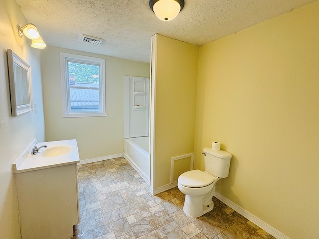 96 E St, Towanda, PA 18848 - bathroom with toilet, vanity, stone finish floors, a textured ceiling, and baseboards