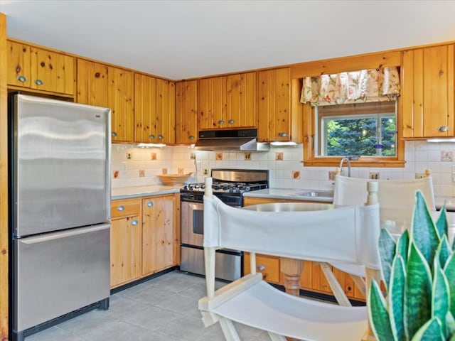 kitchen featuring light tile patterned floors, stainless steel appliances, and sink