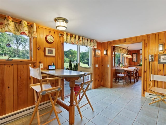 tiled dining area featuring wood walls