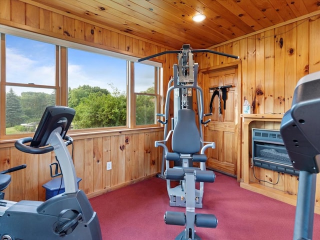 exercise area with carpet flooring, wood ceiling, and wood walls