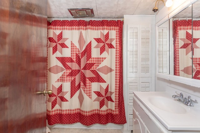 bathroom with vanity and curtained shower