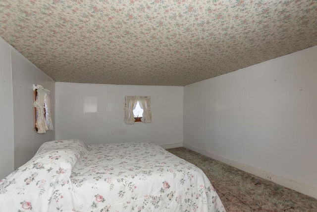 bedroom with carpet and a textured ceiling