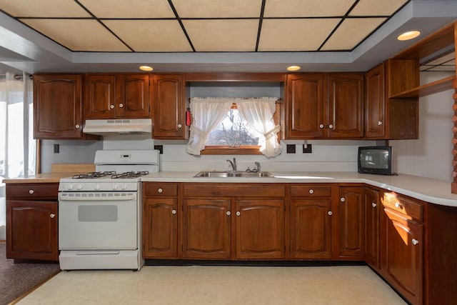 kitchen with sink and white range with gas stovetop