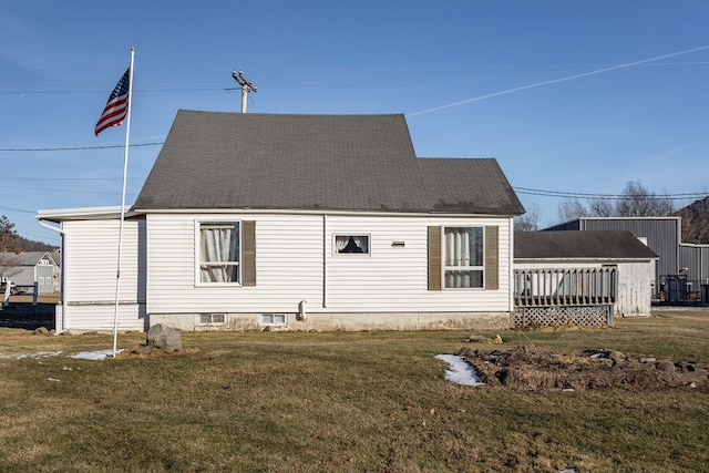 rear view of property featuring a wooden deck and a yard