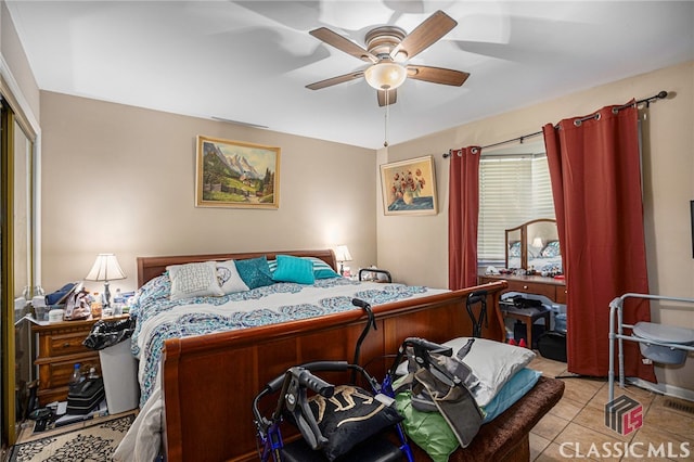 tiled bedroom featuring a closet and ceiling fan