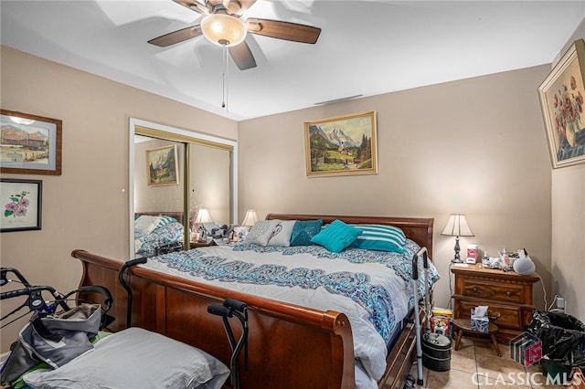 tiled bedroom with a closet and ceiling fan