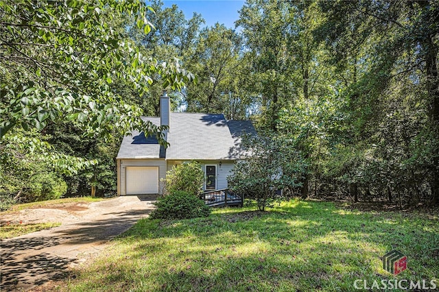 view of front of property with a front yard and a garage