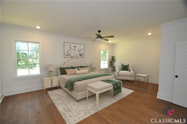 bedroom featuring crown molding, dark hardwood / wood-style floors, and ceiling fan