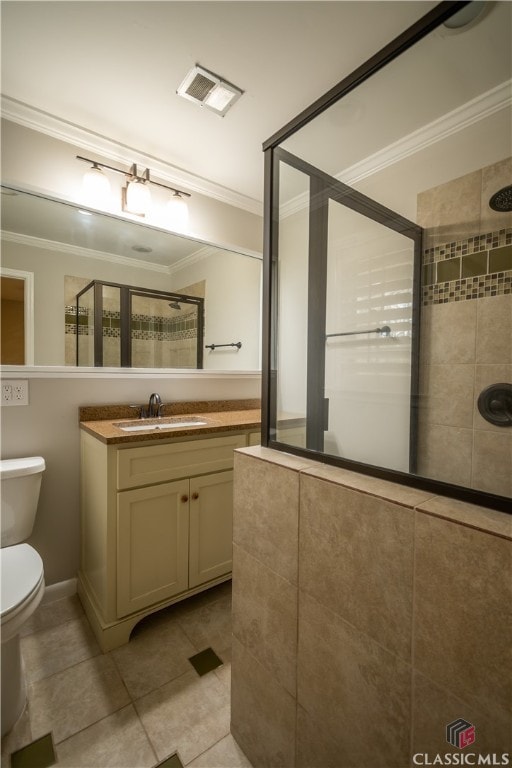 bathroom with crown molding, toilet, tiled shower, and tile floors