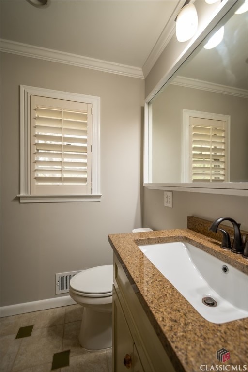 bathroom with tile floors, toilet, vanity, and crown molding