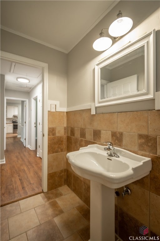 bathroom featuring tile walls, ornamental molding, and tile floors