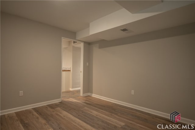 unfurnished room with dark hardwood / wood-style floors