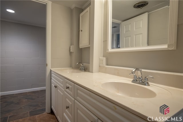 bathroom featuring ornamental molding, double sink, tile floors, and large vanity