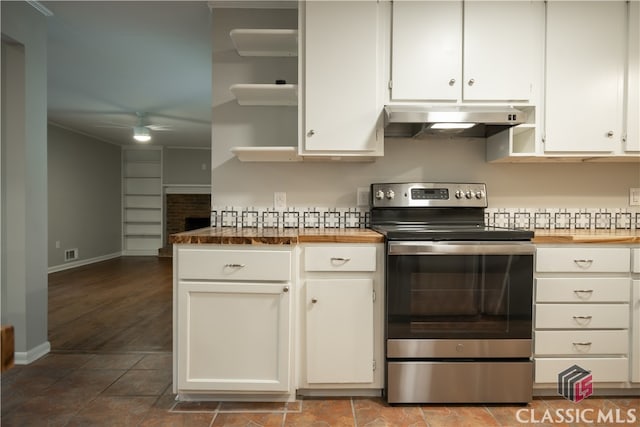 kitchen featuring tile floors, stainless steel electric range, white cabinets, and ceiling fan