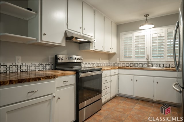 kitchen with white cabinets, appliances with stainless steel finishes, light tile floors, and sink