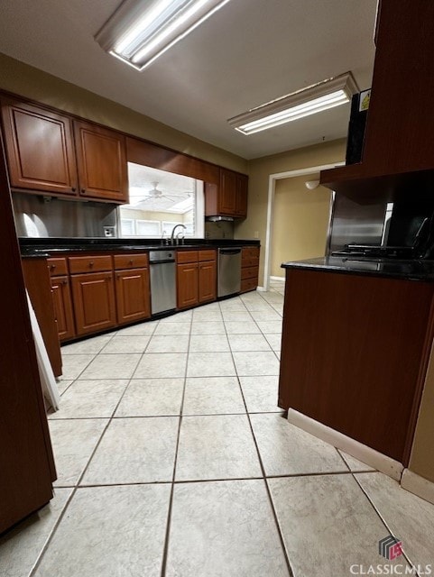 kitchen with sink, light tile patterned floors, and dishwasher