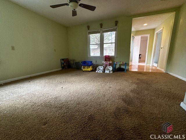 empty room with carpet floors and ceiling fan