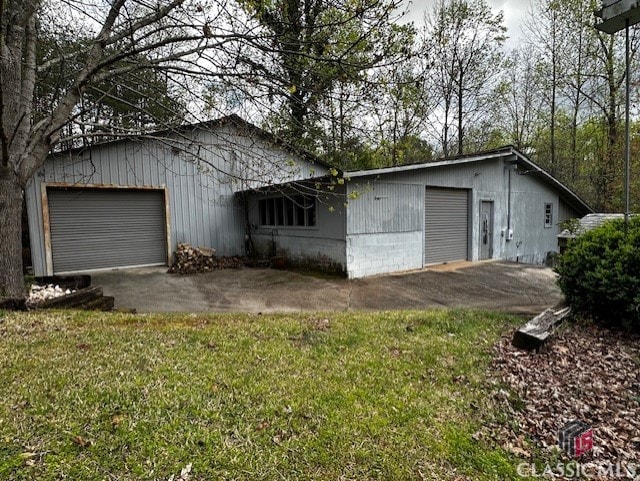 exterior space featuring a lawn and a garage