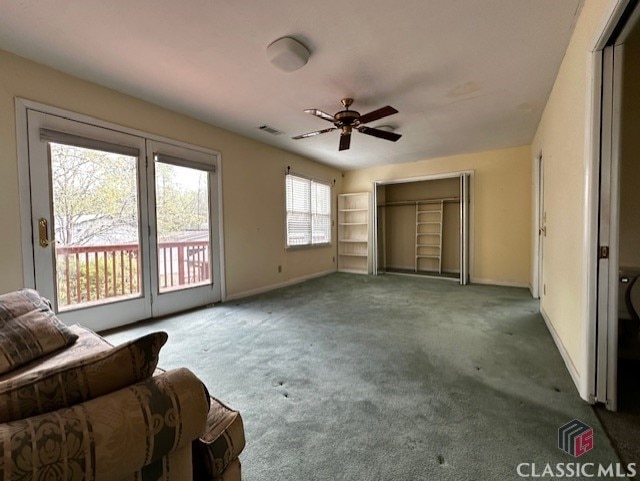 interior space featuring carpet floors and ceiling fan