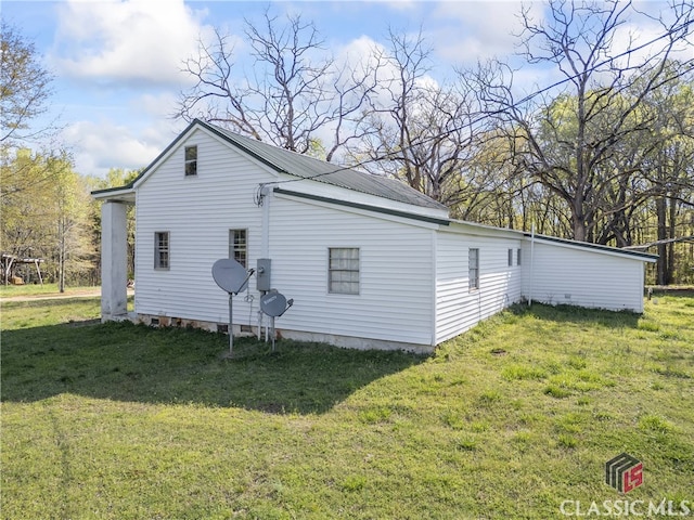 back of house with a yard