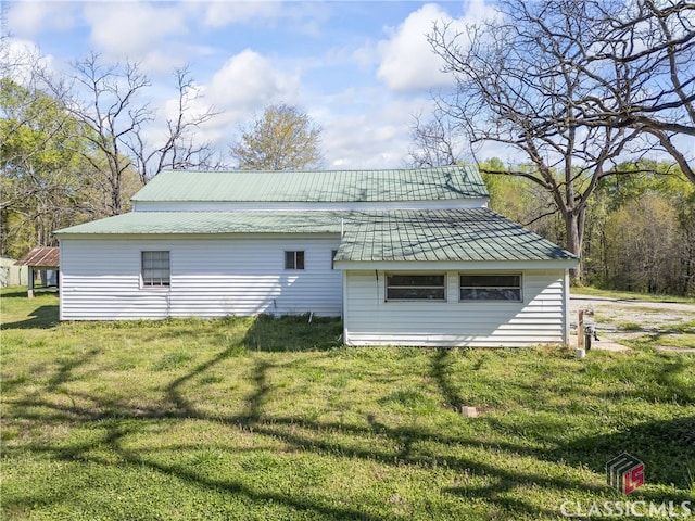 rear view of property with a lawn