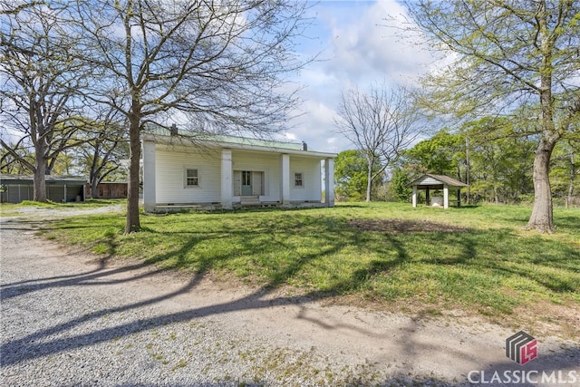 view of front of house with a gazebo and a front lawn