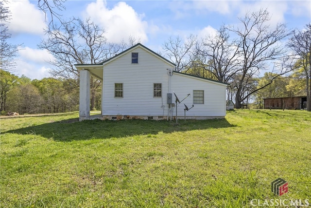 back of property with a lawn