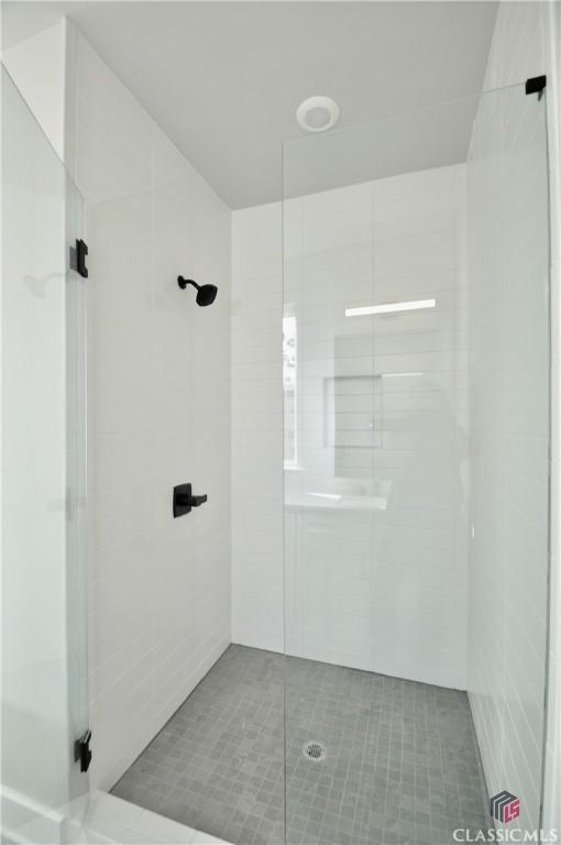 bathroom featuring tile patterned flooring and walk in shower