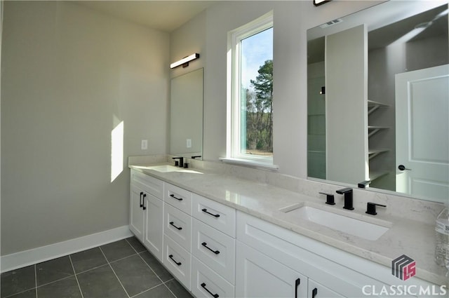 bathroom with tile patterned floors and vanity