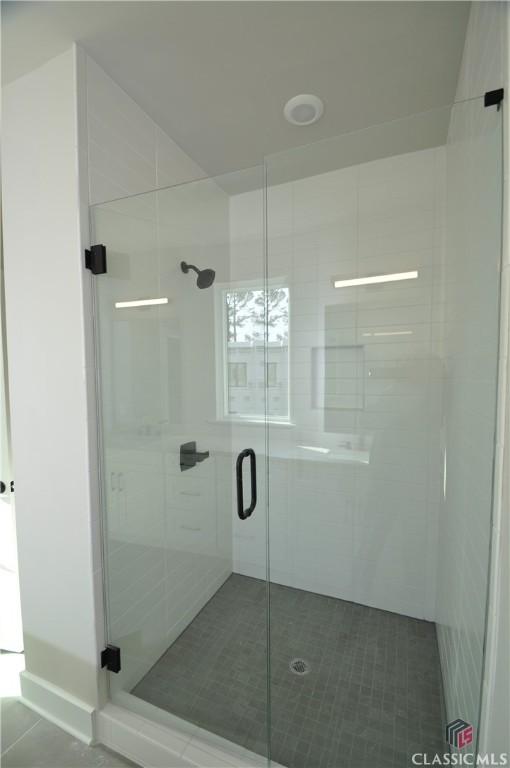 bathroom featuring tile patterned floors and walk in shower