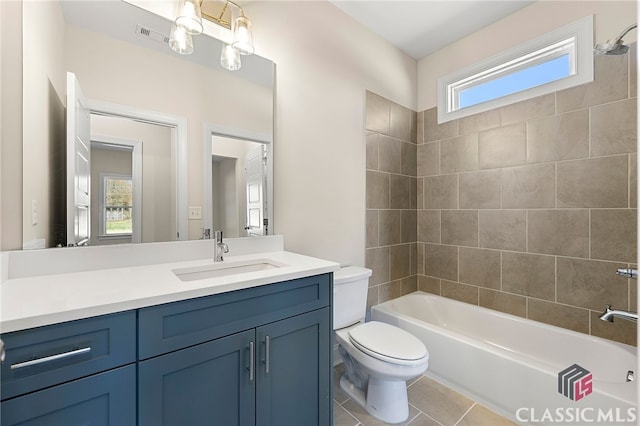 full bathroom with tiled shower / bath combo, oversized vanity, a wealth of natural light, and tile flooring