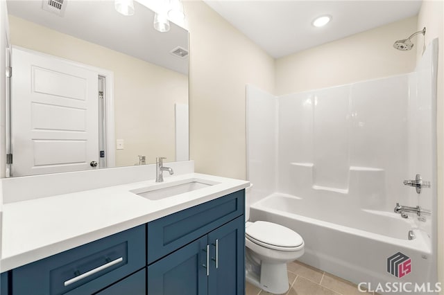 full bathroom featuring washtub / shower combination, vanity, toilet, and tile floors